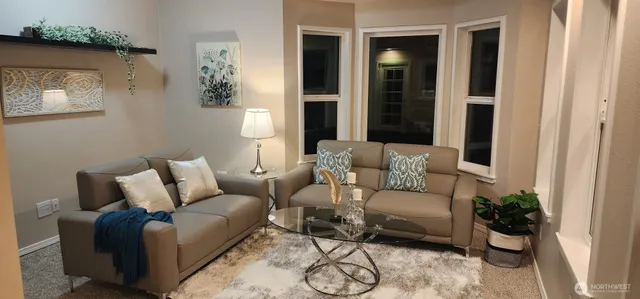a living room with furniture and a potted plant