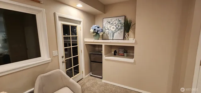 a view of a livingroom with an empty space and a window
