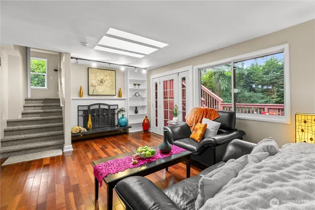 a living room with furniture a large window and a fireplace