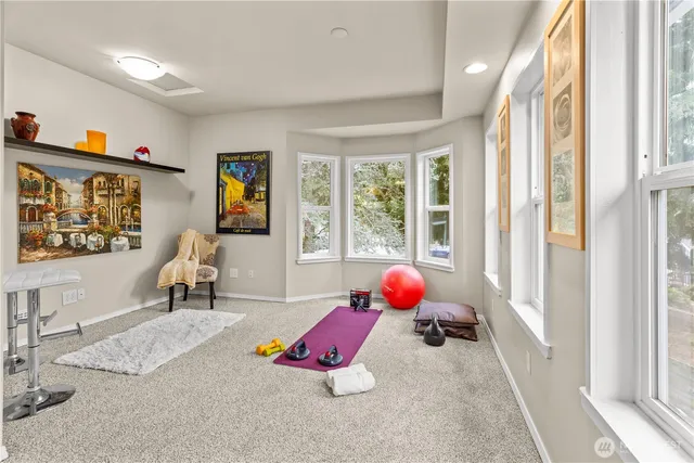 a bedroom with furniture and a large window