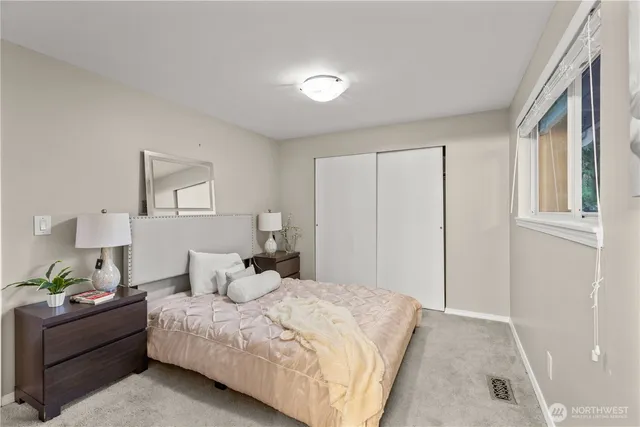 a bedroom with a bed and a painting on the wall