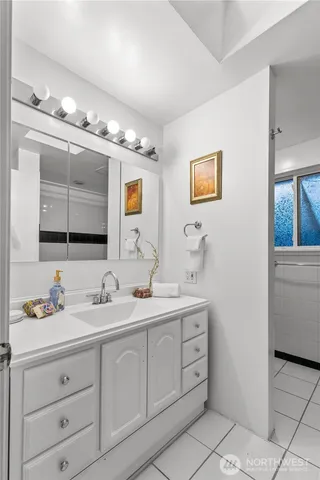 a bathroom with a double vanity sink and a mirror