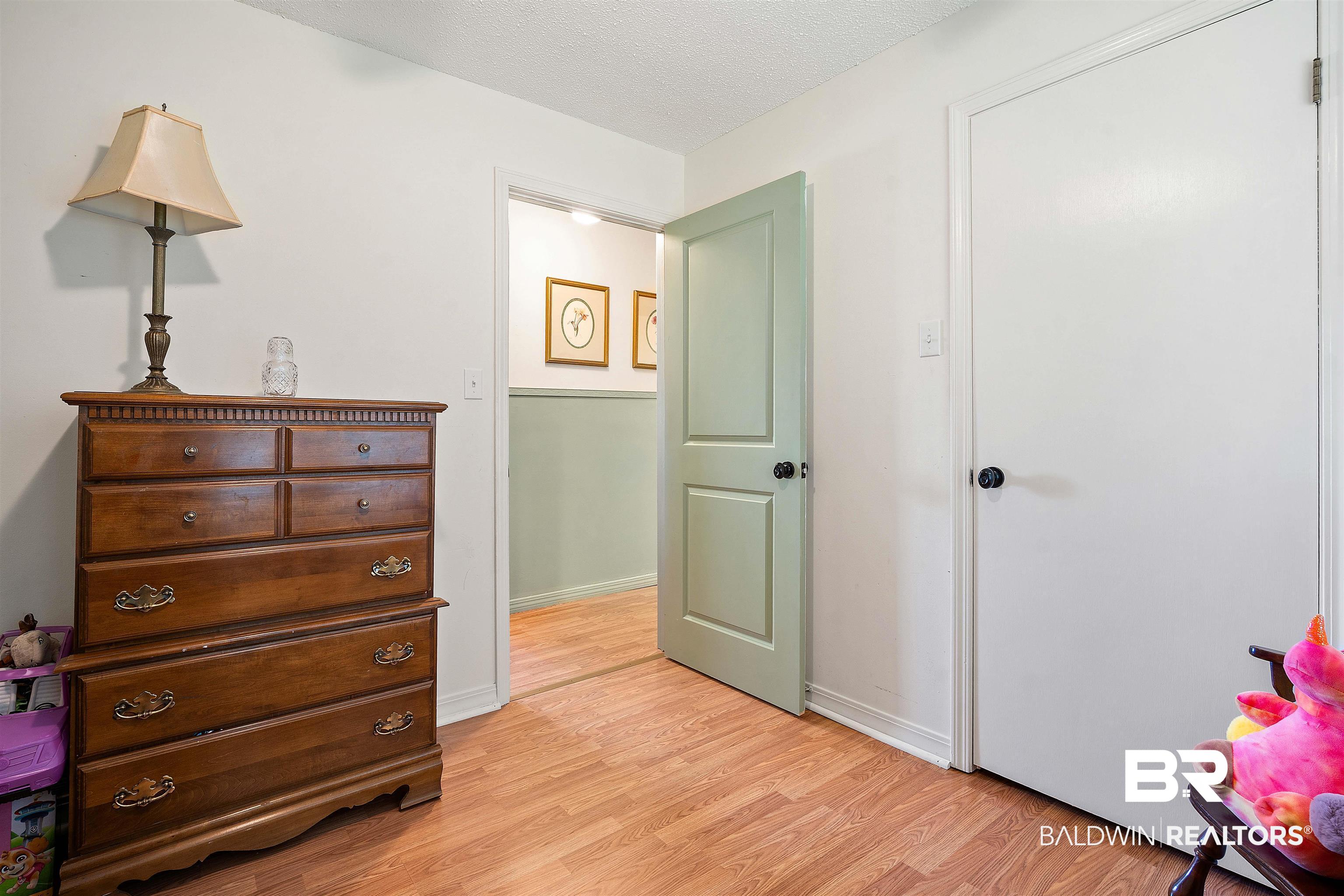 22 Horace Odom Road Millry, AL 36558 - Photo 27 of 39 Bedroom with light wood-style floors and a textured ceiling