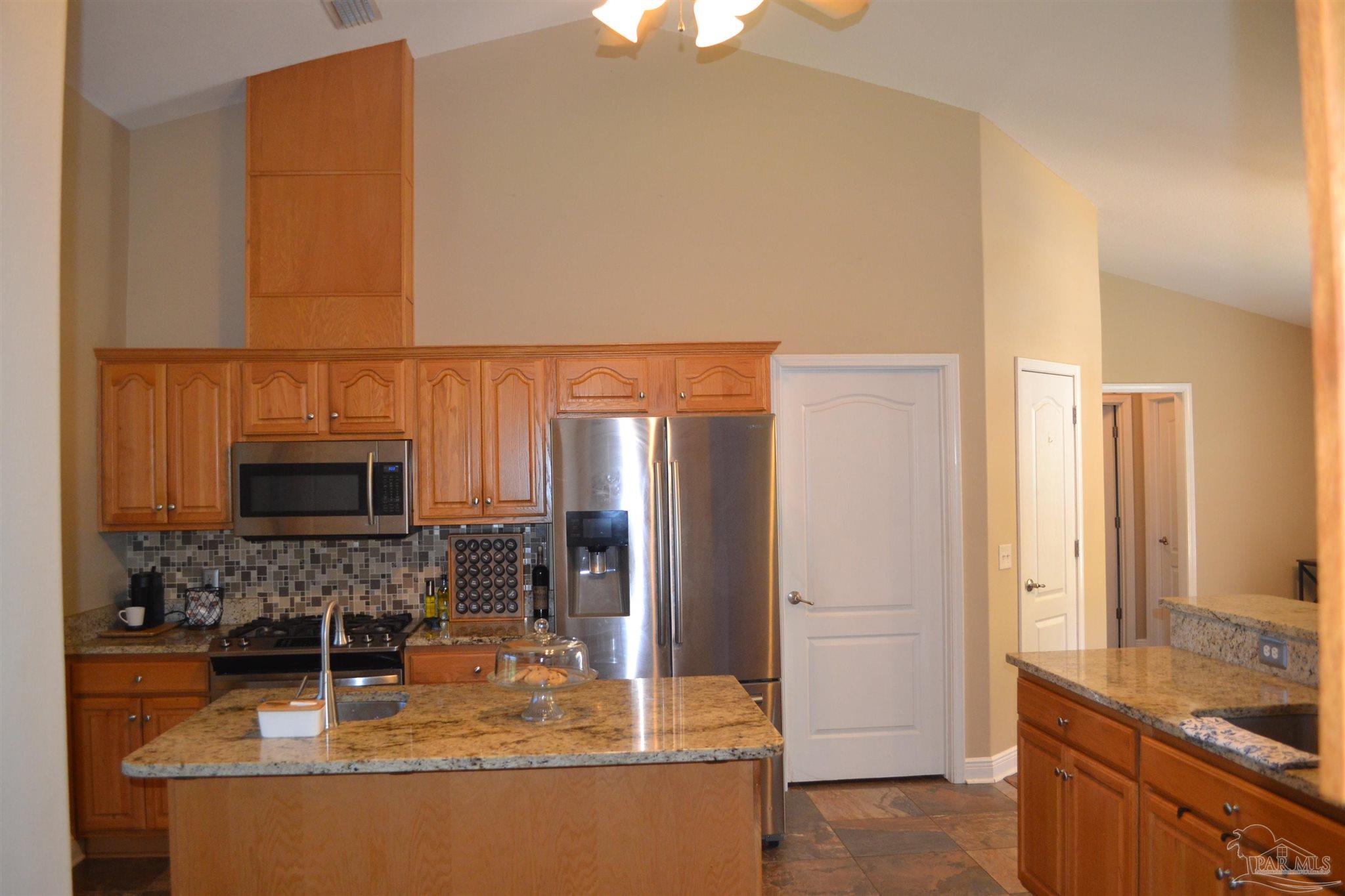 3055 Wallace Lake Road Pace, FL 32571 - Photo 14 of 33 a bathroom with a granite countertop sink a mirror and shower