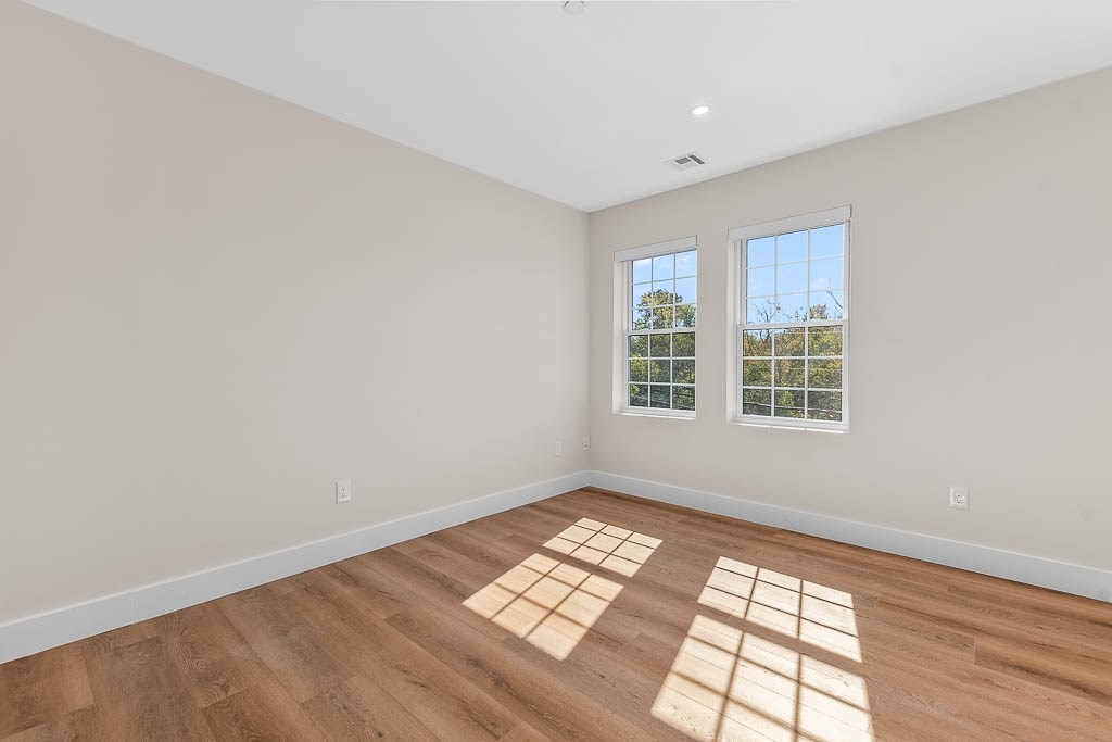 22 Everett Street, Unit 424 Westwood, MA 02090 - Photo 14 of 30 wooden floor in an empty room with a window