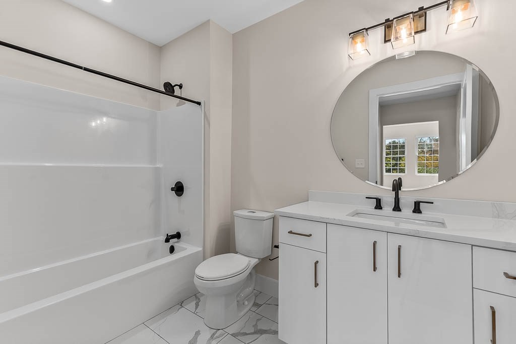 22 Everett Street, Unit 424 Westwood, MA 02090 - Photo 16 of 30 a bathroom with a sink a toilet and a mirror