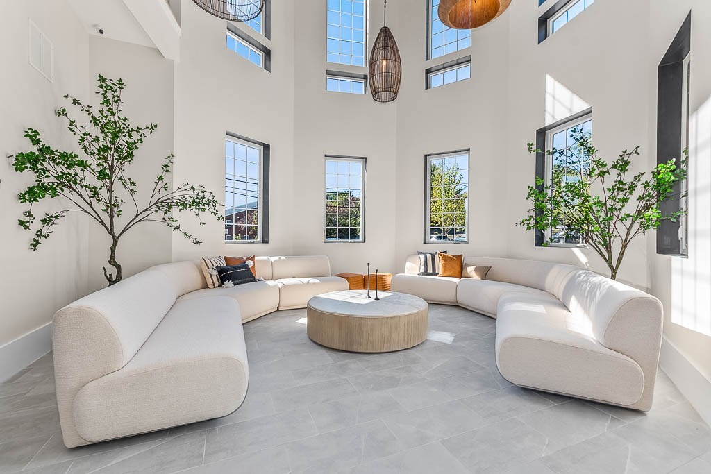 22 Everett Street, Unit 424 Westwood, MA 02090 - Photo 26 of 30 a living room with furniture and a chandelier
