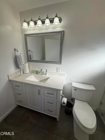 a white toilet sitting next to a shower