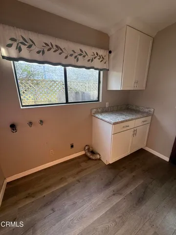 a view of a kitchen with a sink cabinets and wooden floor
