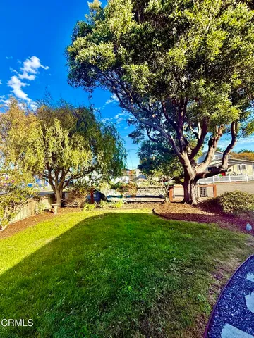 a view of yard with swimming pool and green space
