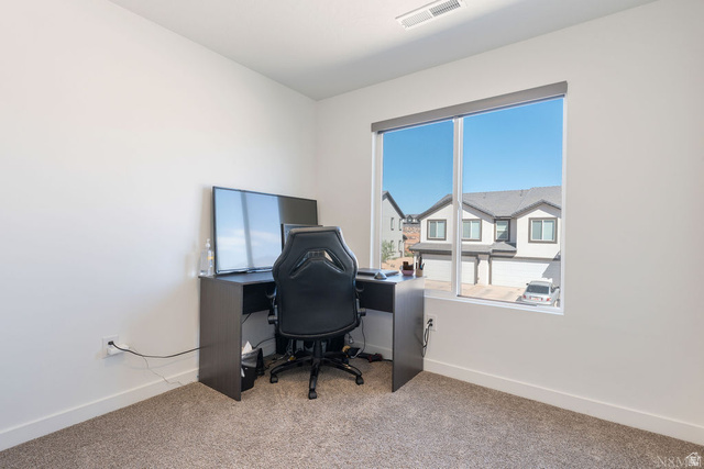 1693 Devils Gdn Lane Washington, UT 84780 - Photo 20 of 64 Bright room with an expansive window, neutral wall paint, and gray carpet flooring