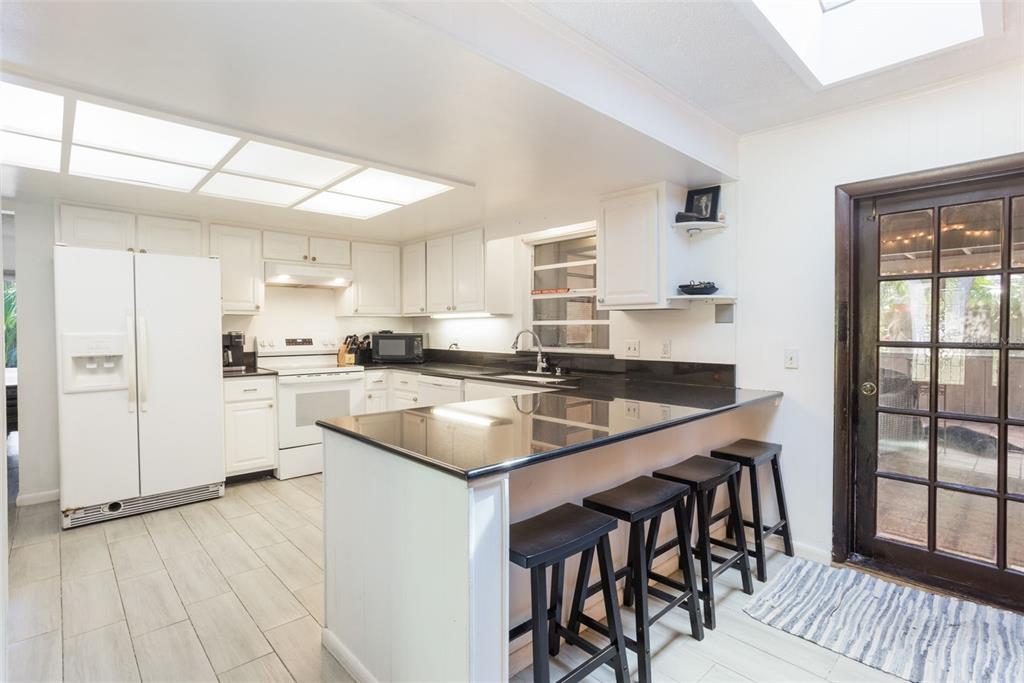 1029 Antelope Trail Winter Springs, FL 32708 - Photo 11 of 28 a kitchen with granite countertop a sink stove and refrigerator