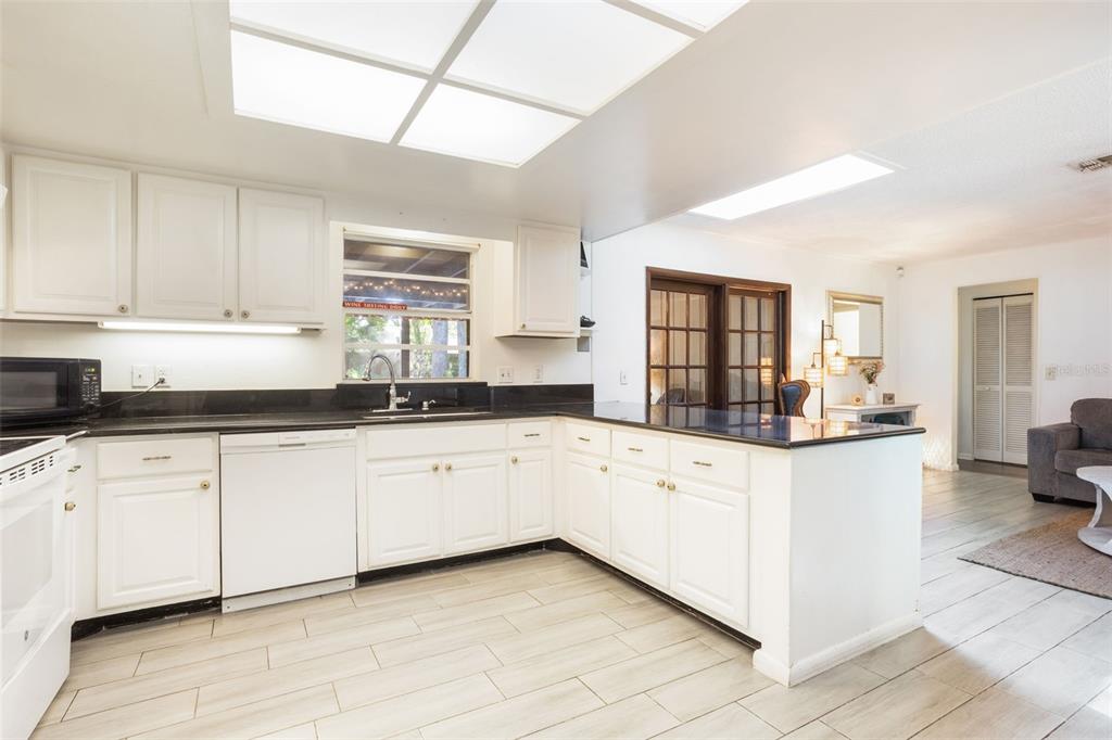 1029 Antelope Trail Winter Springs, FL 32708 - Photo 13 of 28 a kitchen with granite countertop white cabinets white stainless steel appliances with a sink and dishwasher