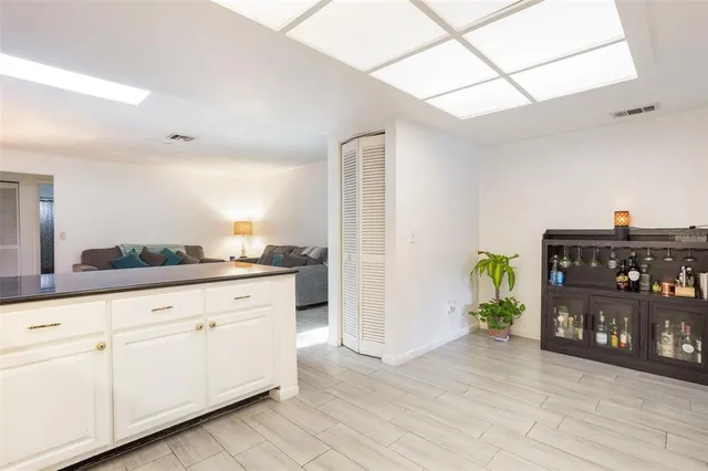 a bedroom with a bed and a refrigerator