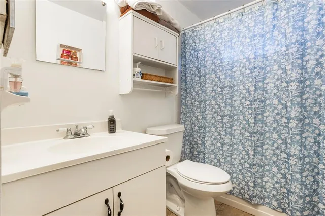 a bathroom with a sink vanity and a mirror
