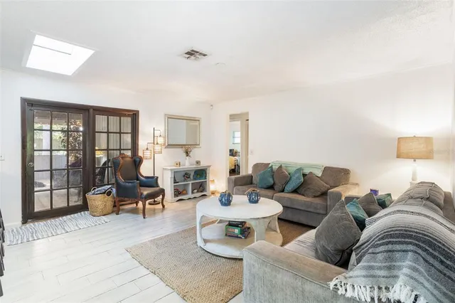 a living room with furniture and view of kitchen