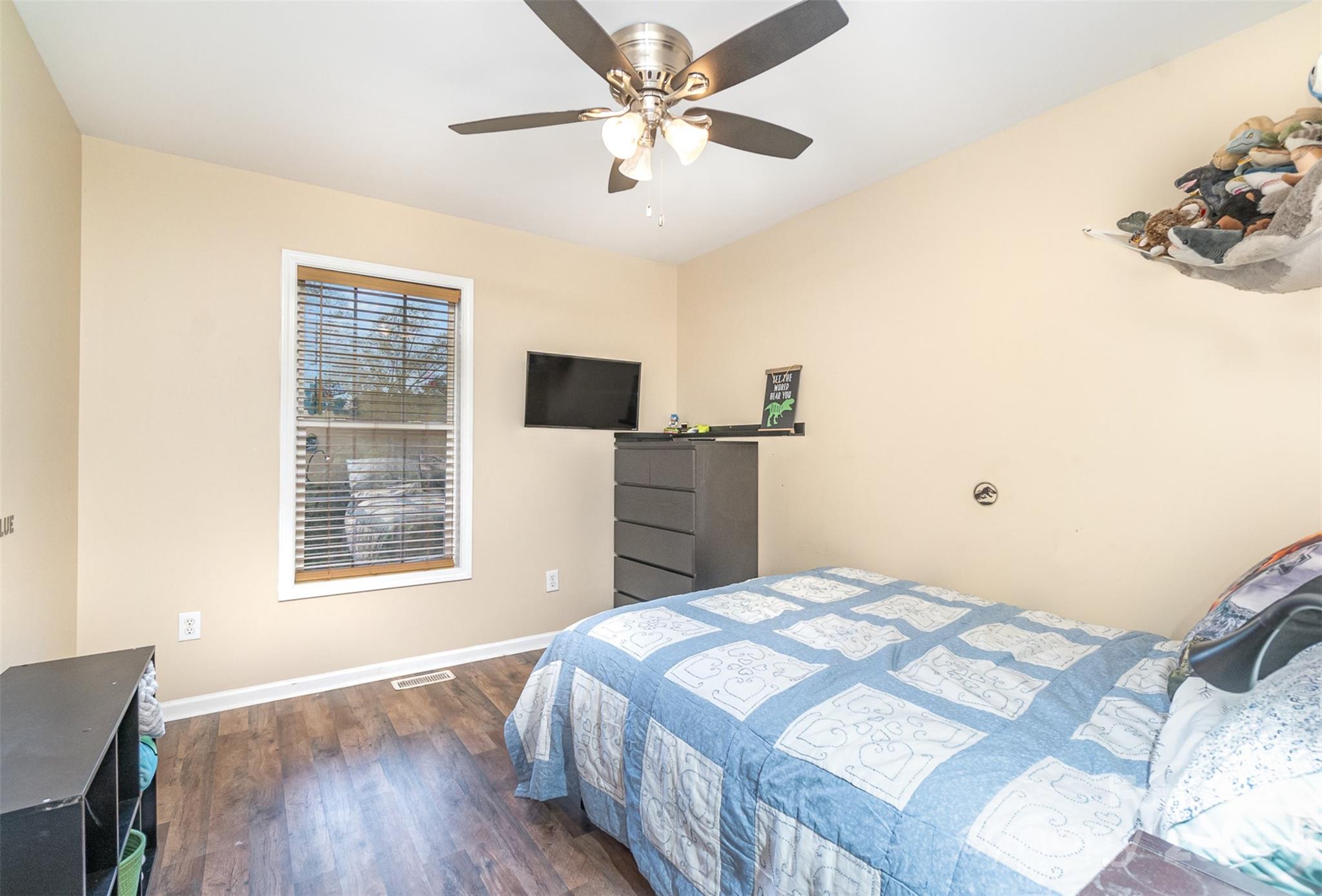 3526 Herman Sipe Road Conover, NC 28613 - Photo 17 of 29 a bedroom with a bed and a dresser with wooden floor