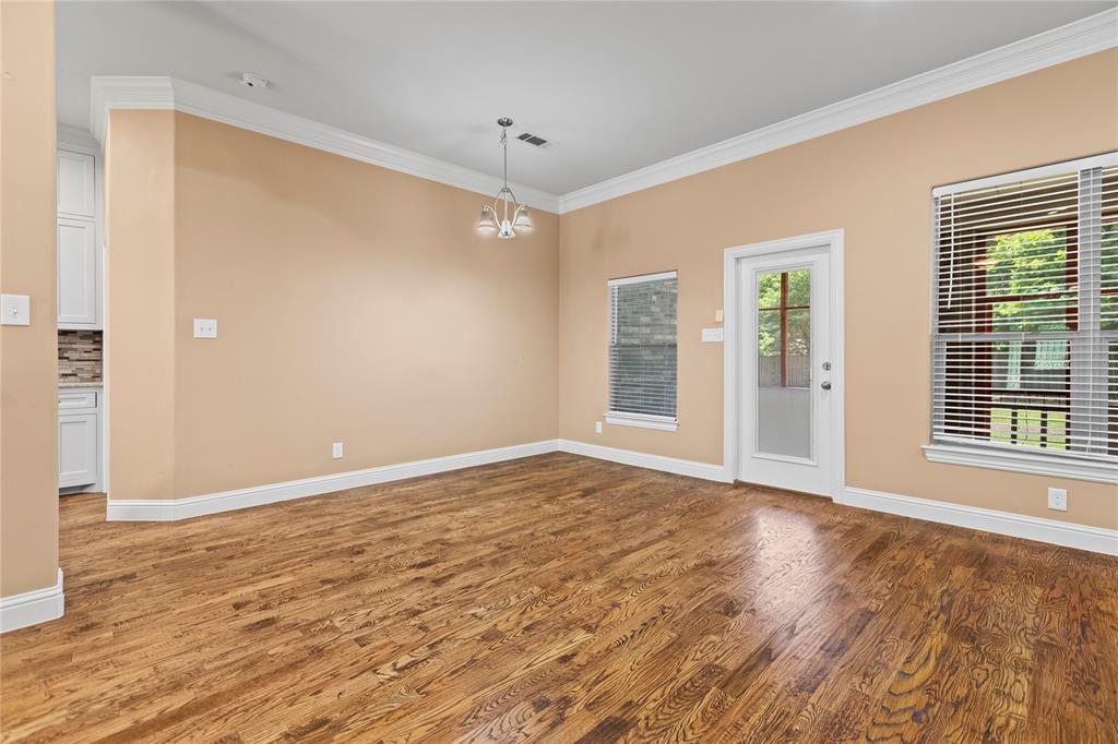 7806 Garner Road Rowlett, TX 75088 - Photo 12 of 34 a view of an empty room with wooden floor and a window