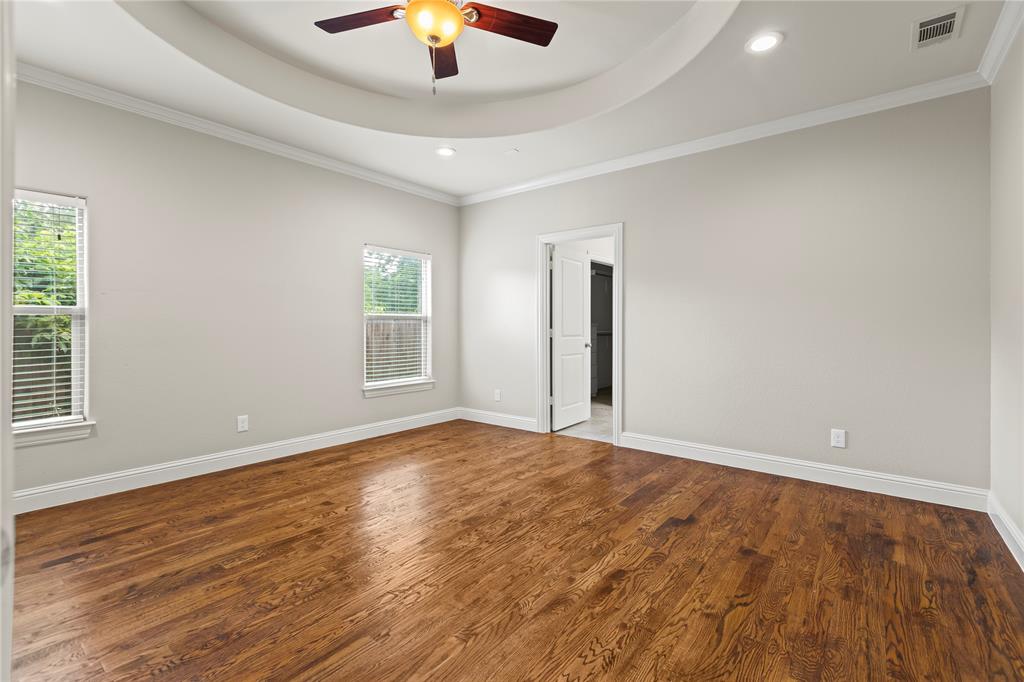 7806 Garner Road Rowlett, TX 75088 - Photo 14 of 34 an empty room with wooden floor chandelier fan and windows