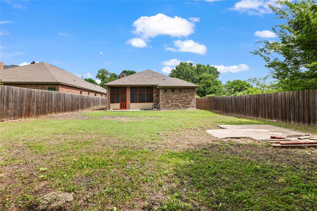 7806 Garner Road Rowlett, TX 75088 - Photo 32 of 34 a view of a house with backyard and a tree