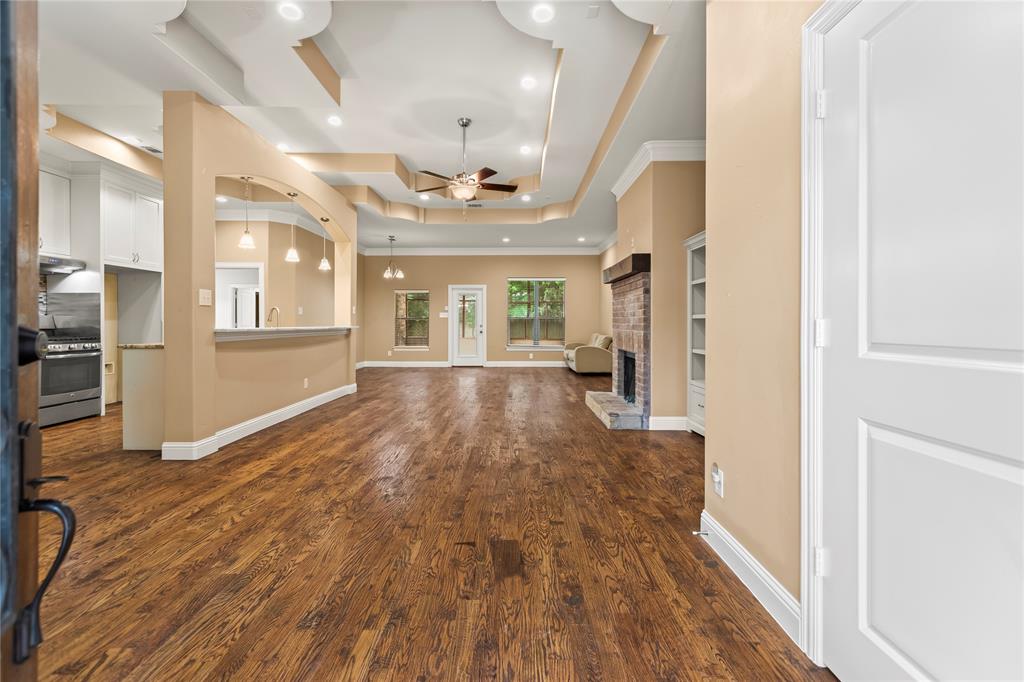 7806 Garner Road Rowlett, TX 75088 - Photo 6 of 34 a view of a big room with wooden floor and windows