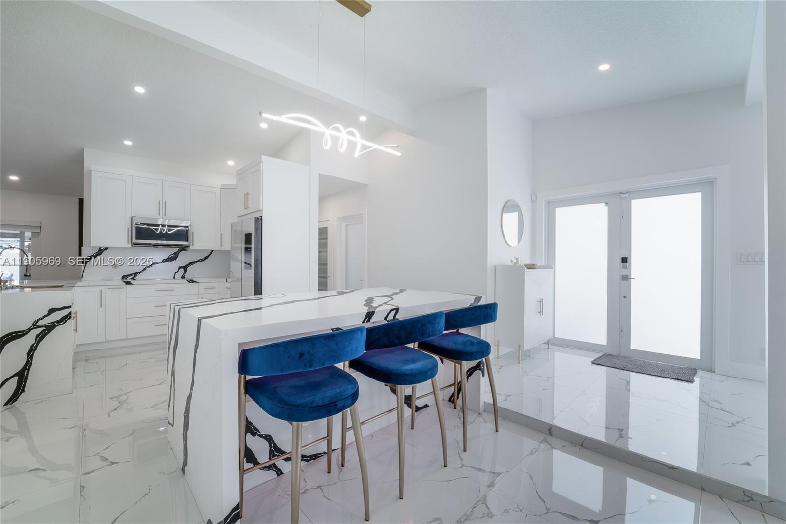 9746 Southwest 147th Court Miami, FL 33196 - Photo 11 of 42 a kitchen with stainless steel appliances kitchen island granite countertop a dining table chairs and sink