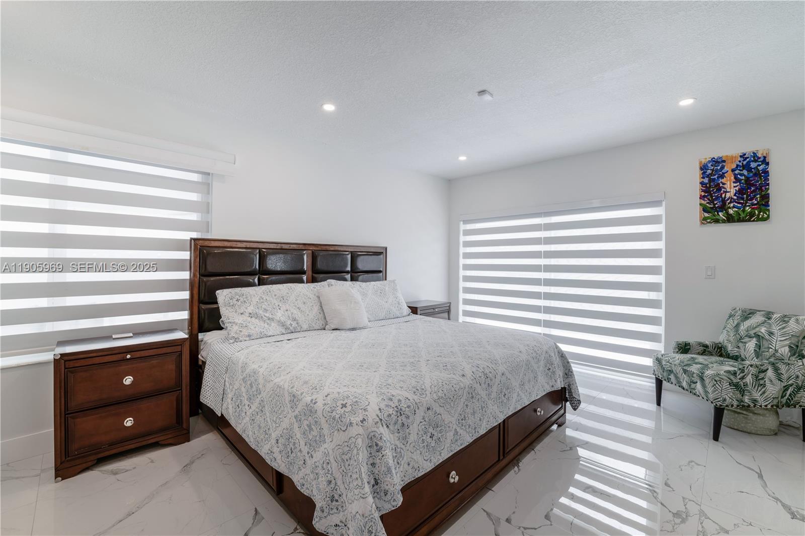 9746 Southwest 147th Court Miami, FL 33196 - Photo 18 of 42 a bedroom with a bed and a night stand