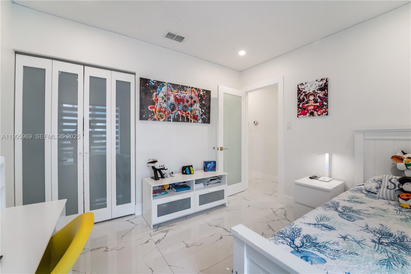 9746 Southwest 147th Court Miami, FL 33196 - Photo 20 of 42 a bedroom with a bed and a view of bathroom