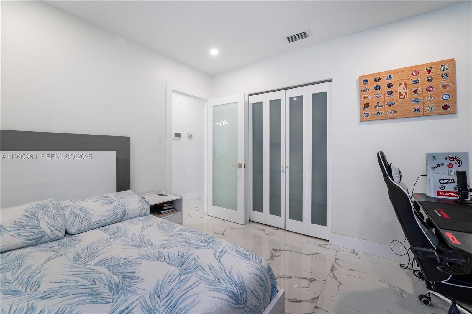 9746 Southwest 147th Court Miami, FL 33196 - Photo 21 of 42 a bedroom with a large bed and a chair