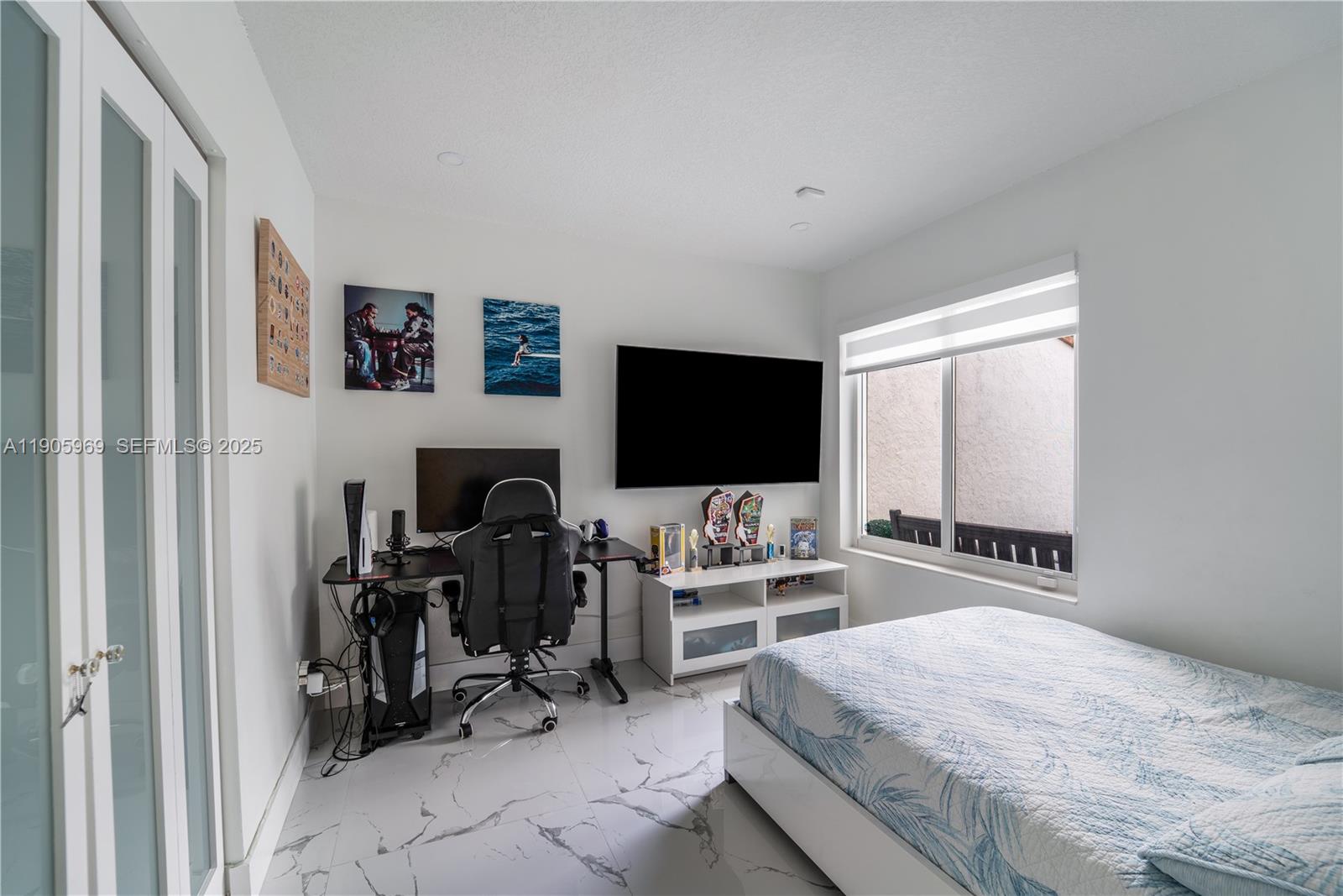 9746 Southwest 147th Court Miami, FL 33196 - Photo 23 of 42 a bedroom with furniture a flat screen tv and a fireplace