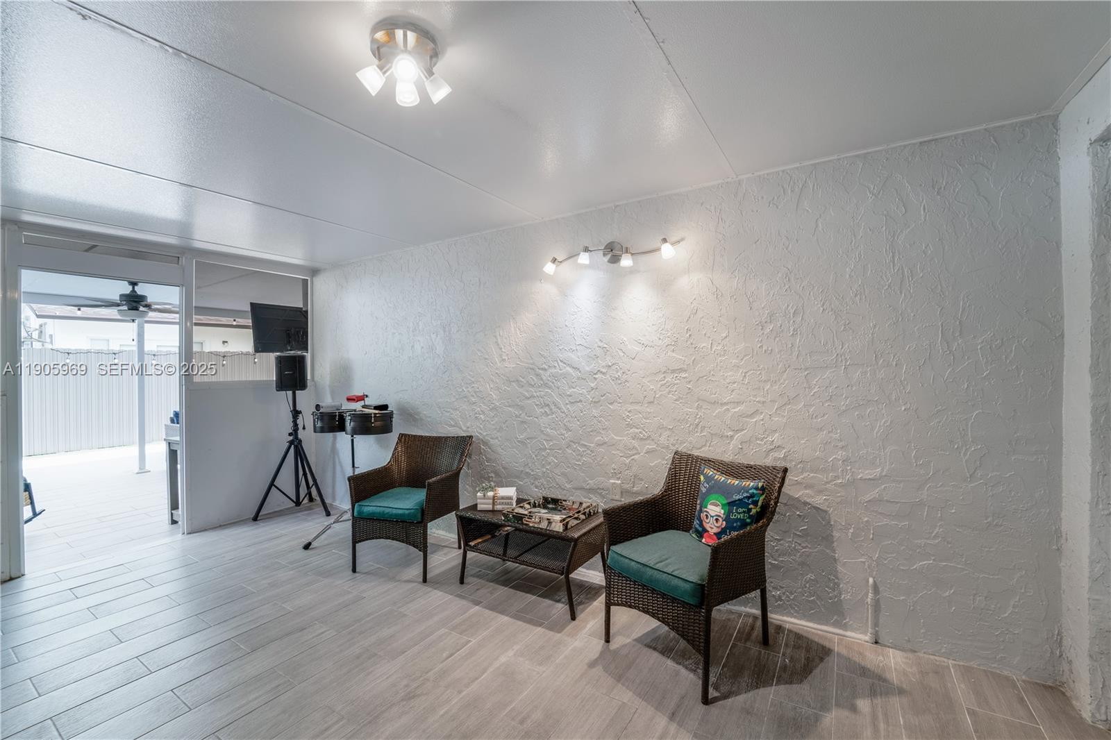 9746 Southwest 147th Court Miami, FL 33196 - Photo 26 of 42 a living room with furniture and a chandelier