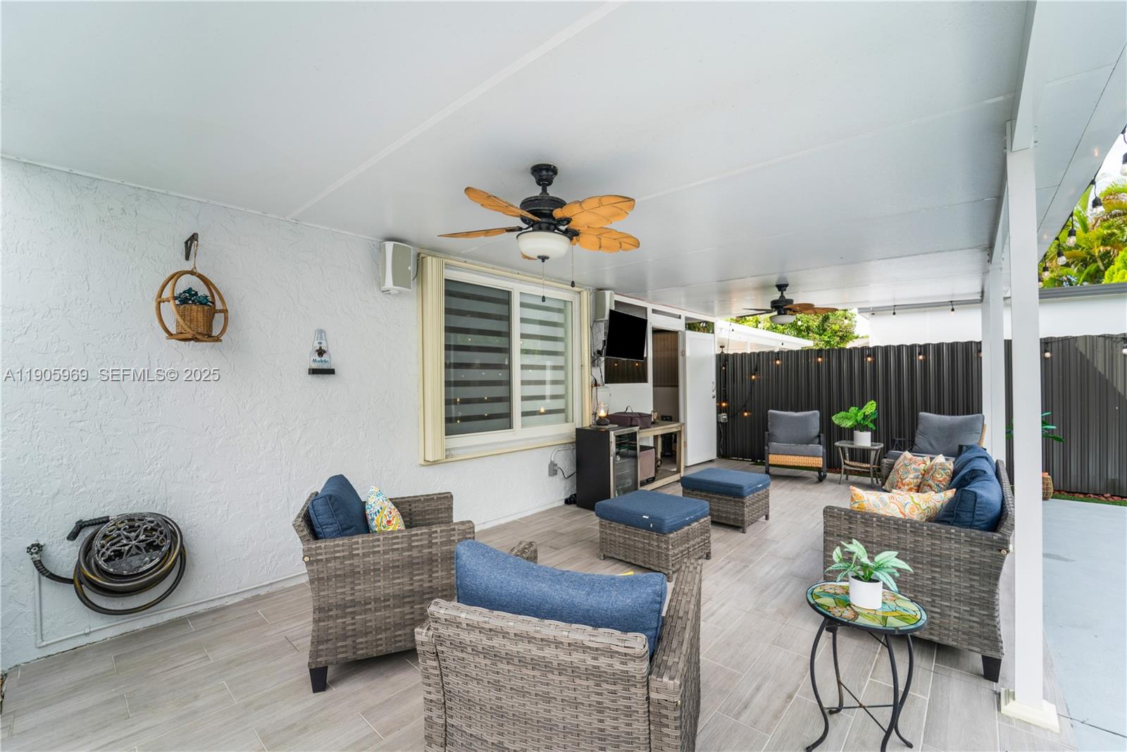 9746 Southwest 147th Court Miami, FL 33196 - Photo 29 of 42 a living room with furniture a flat screen tv and a table