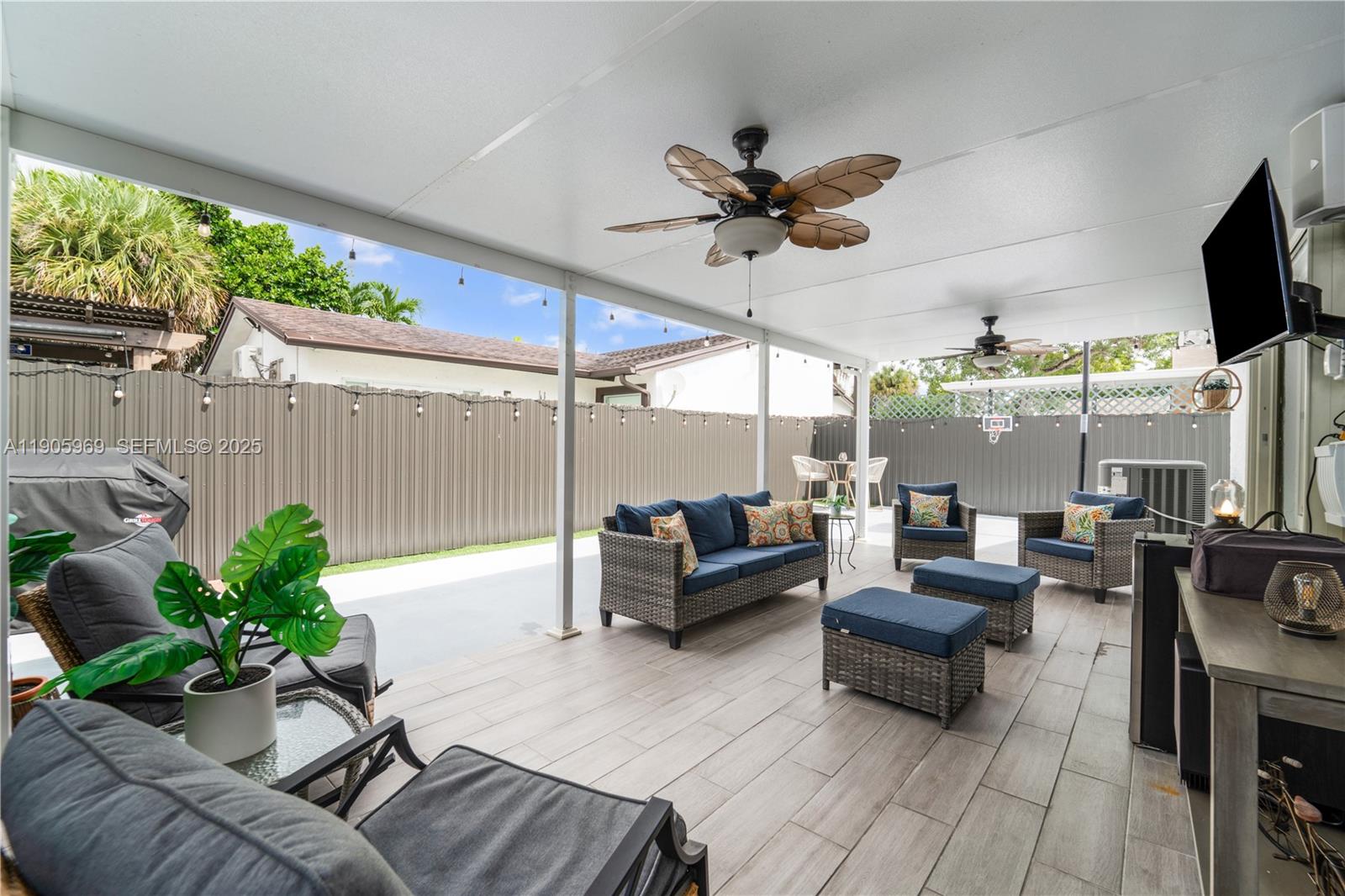9746 Southwest 147th Court Miami, FL 33196 - Photo 30 of 42 a living room with patio furniture and a potted plants