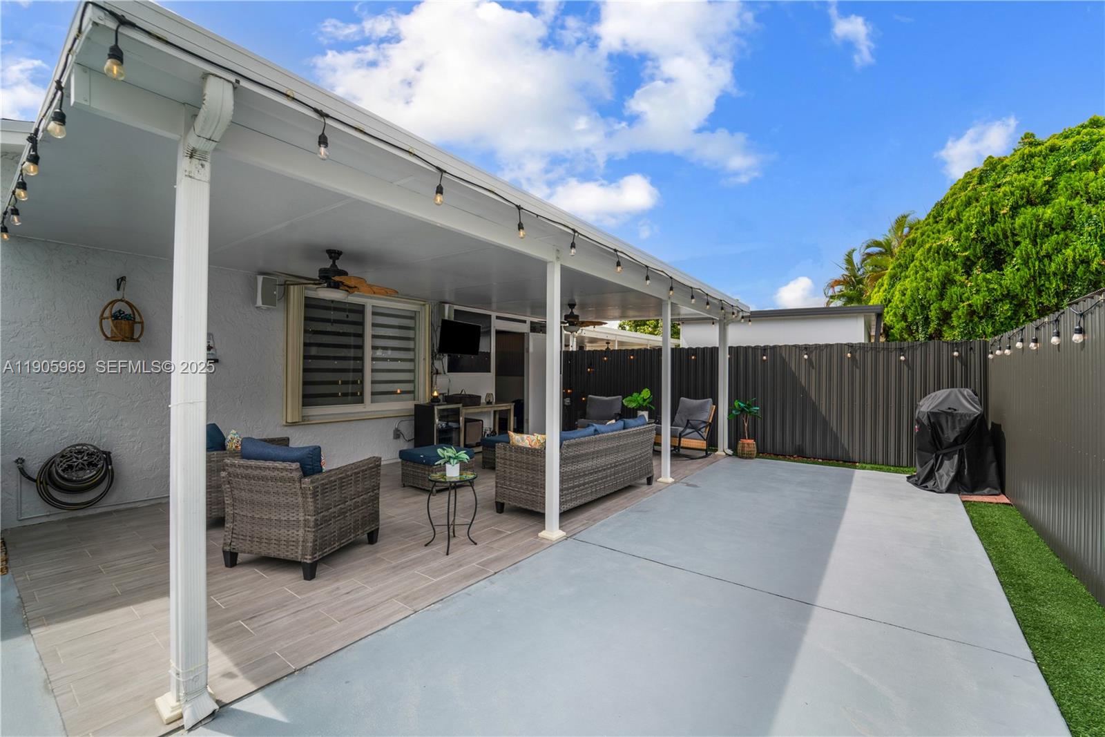 9746 Southwest 147th Court Miami, FL 33196 - Photo 33 of 42 a view of a porch with furniture and a tree