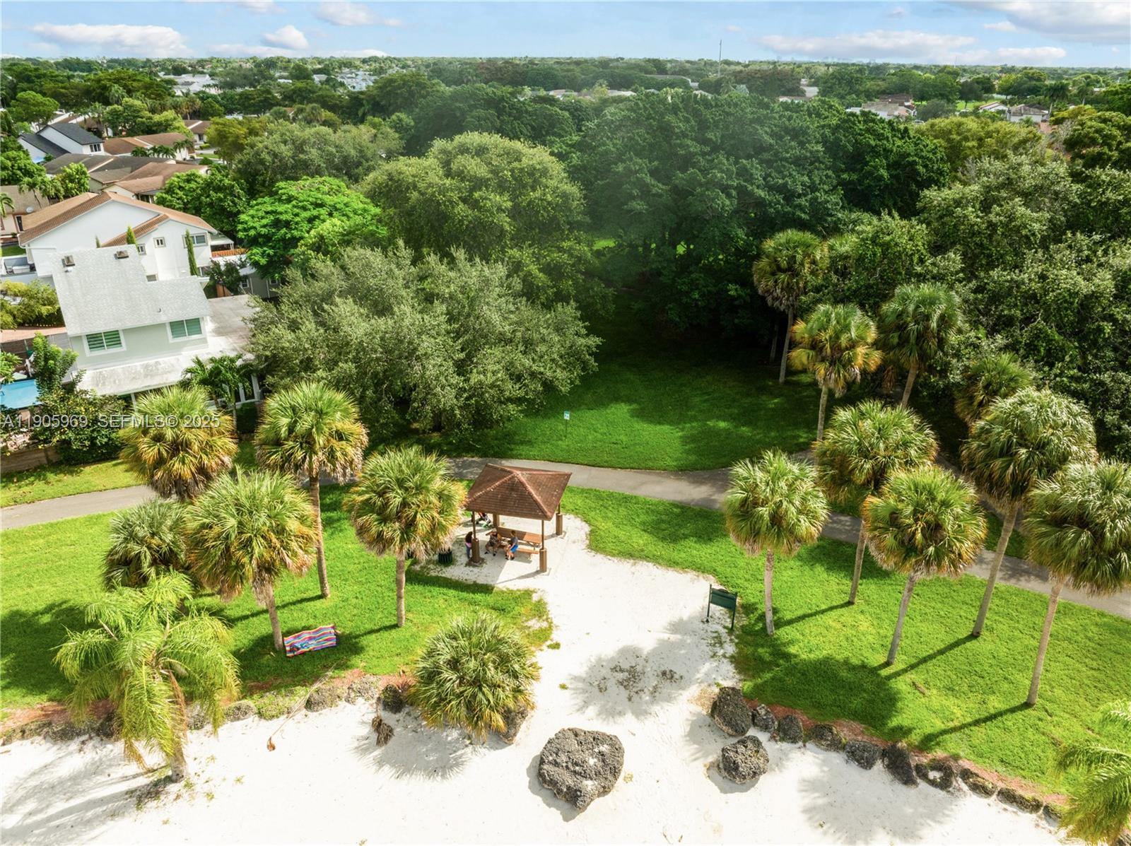 9746 Southwest 147th Court Miami, FL 33196 - Photo 41 of 42 a view of a garden with a building in the background