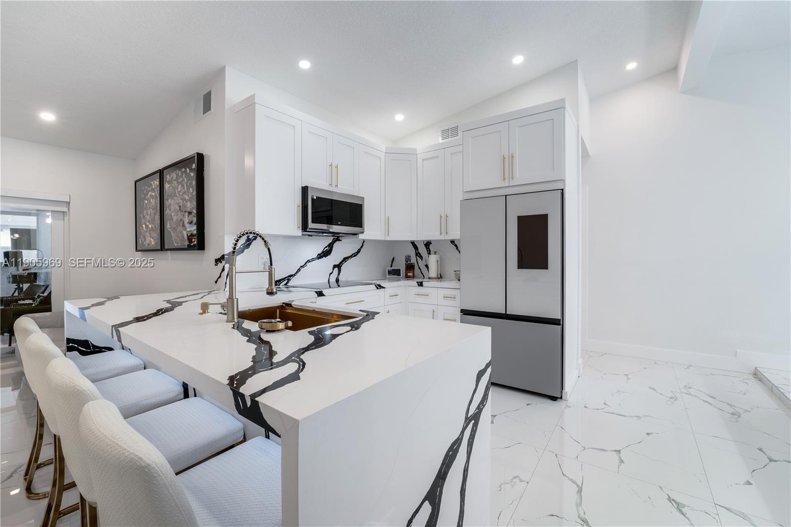 9746 Southwest 147th Court Miami, FL 33196 - Photo 6 of 42 a work room with furniture a flat screen tv and a refrigerator