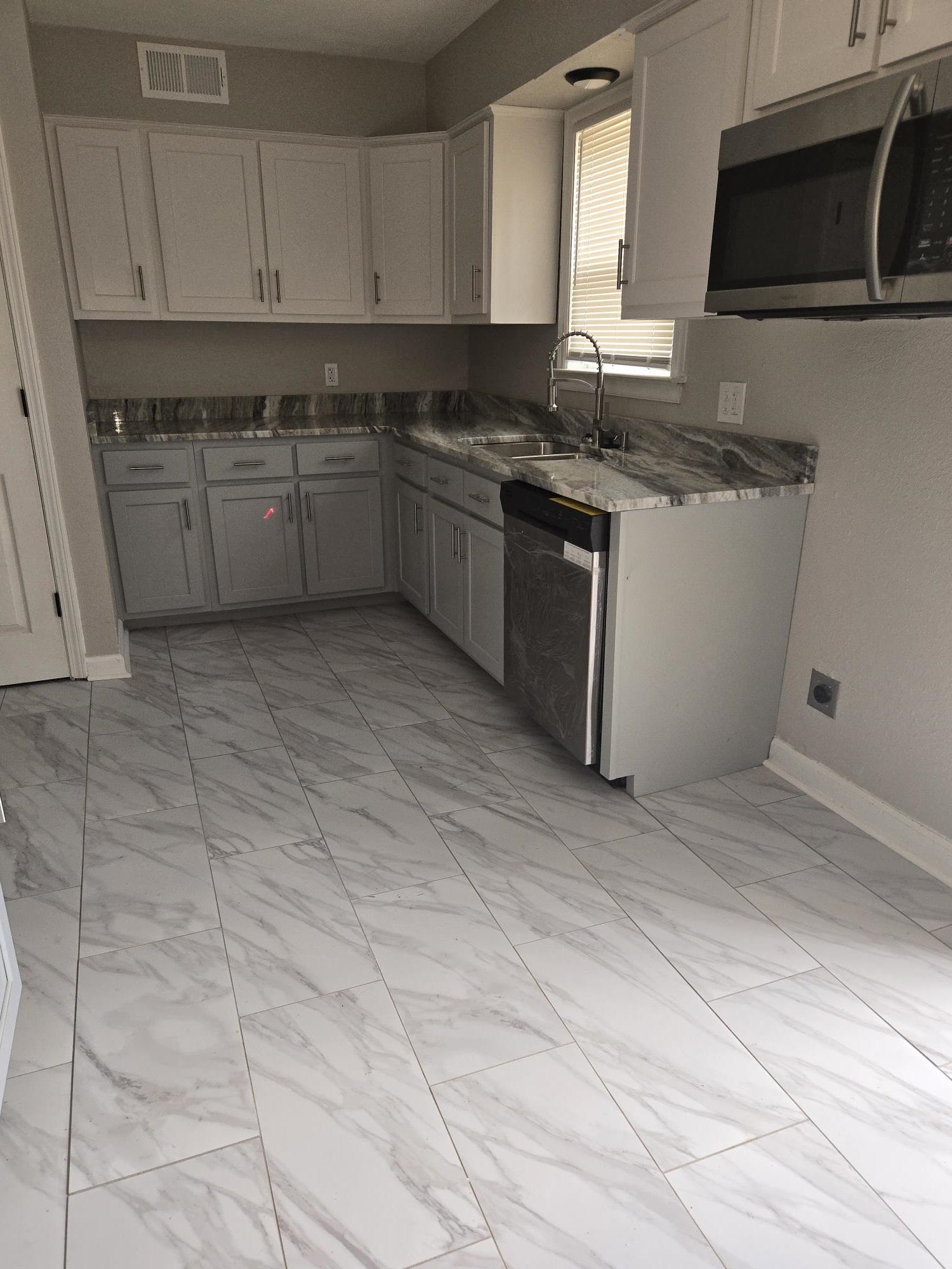 2270 Celeste Drive Memphis, TN 38127 - Photo 4 of 11 Kitchen with baseboards, visible vents, stainless steel appliances, marble finish floor, and a sink