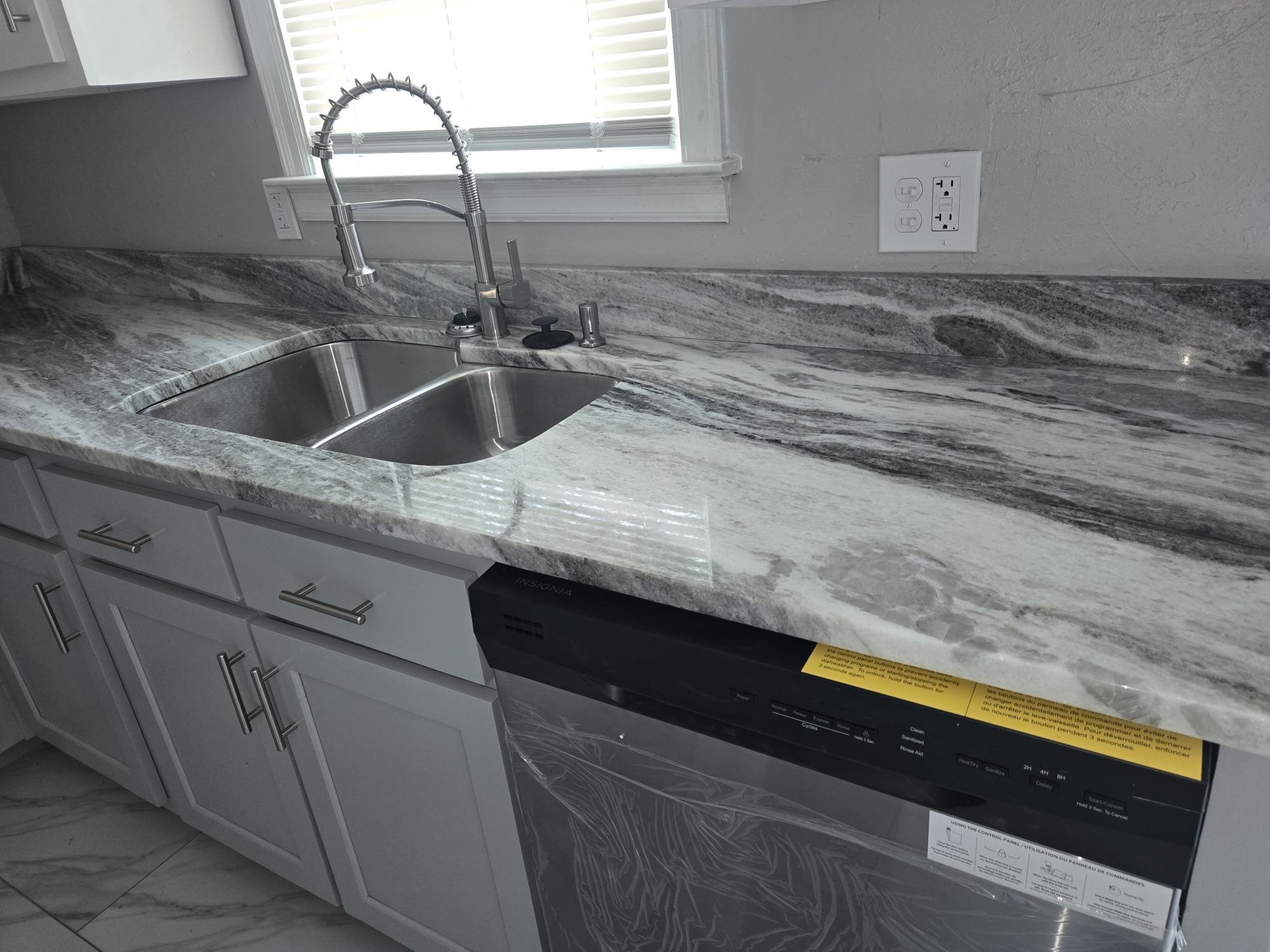 2270 Celeste Drive Memphis, TN 38127 - Photo 5 of 11 Kitchen with dishwasher, marble finish floor, a sink, and light stone counters