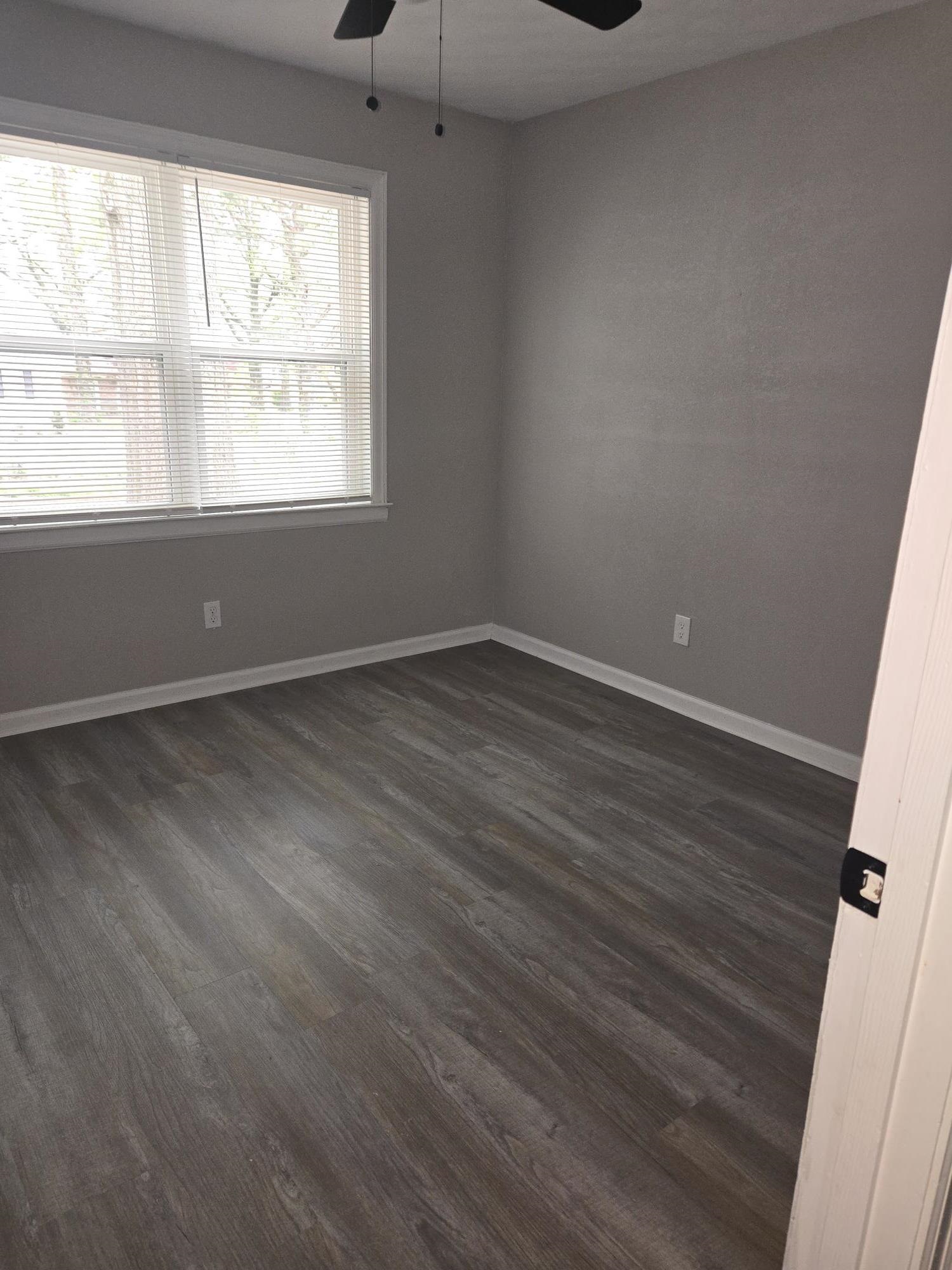 2270 Celeste Drive Memphis, TN 38127 - Photo 7 of 11 Unfurnished room featuring baseboards, a ceiling fan, and dark wood finished floors