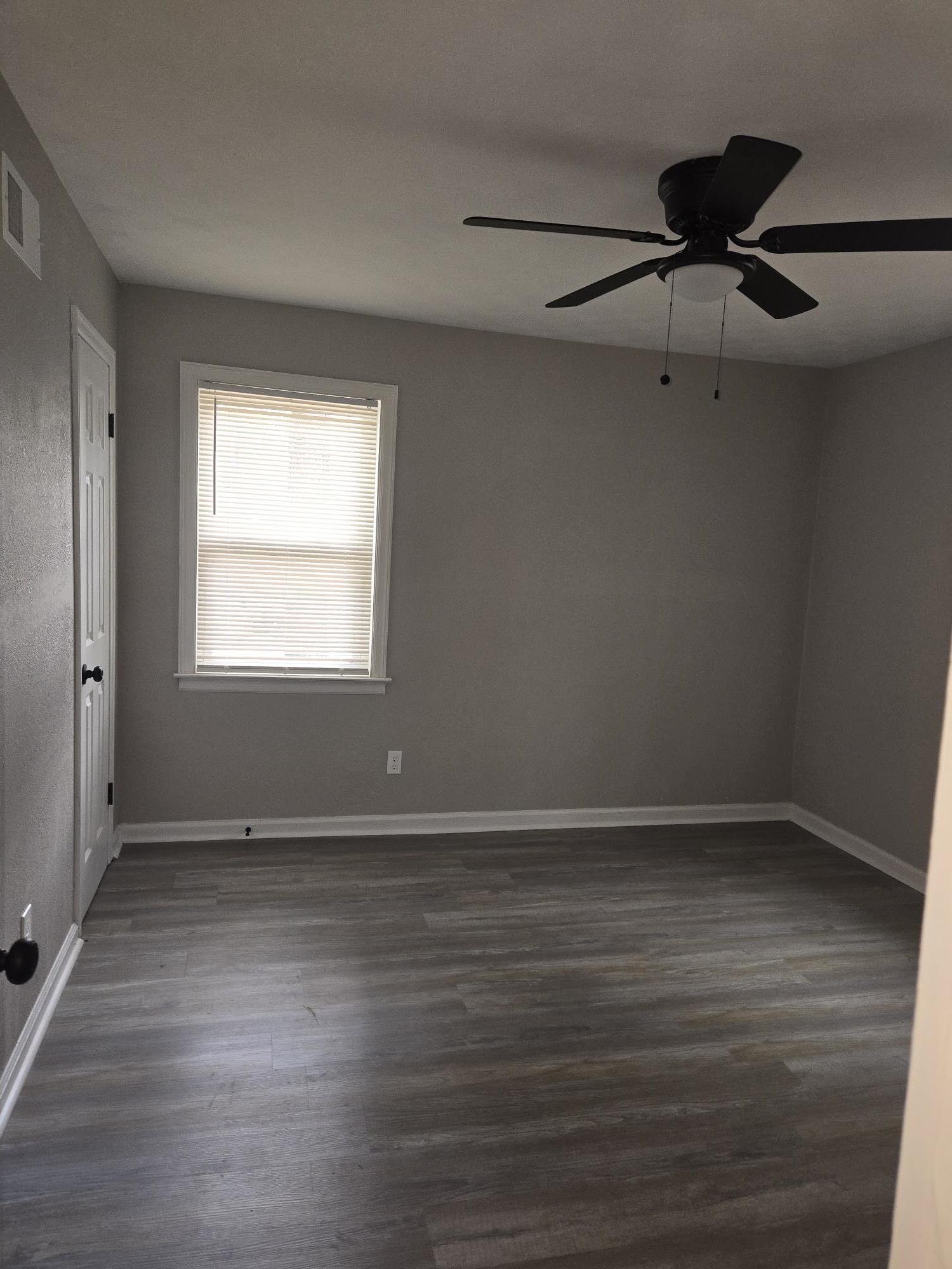 2270 Celeste Drive Memphis, TN 38127 - Photo 10 of 11 Empty room featuring dark wood-style flooring, baseboards, visible vents, and ceiling fan