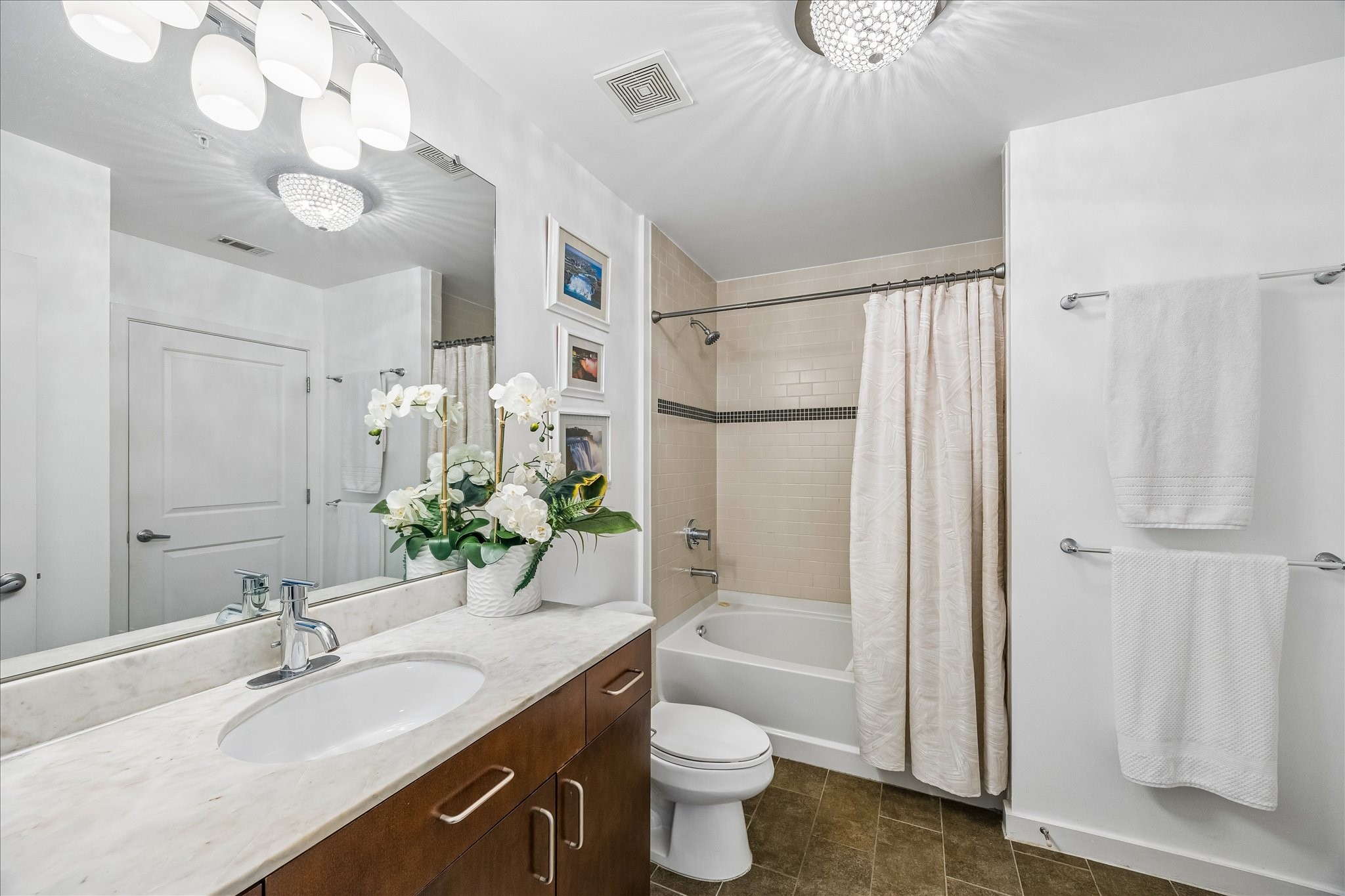 5925 Almeda Road, Unit 11907 Houston, TX 77004 - Photo 13 of 35 a bathroom with a sink a toilet a large mirror and shower