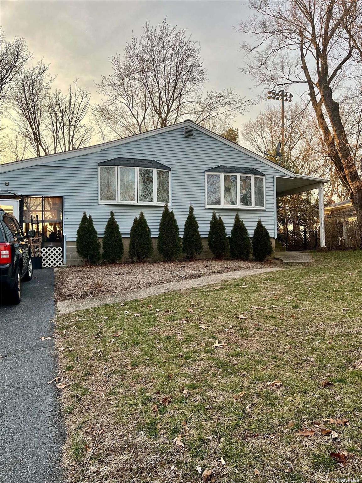 226 Tree Road Centereach, NY 11720 - Photo 1 of 1 a front view of a house with a yard