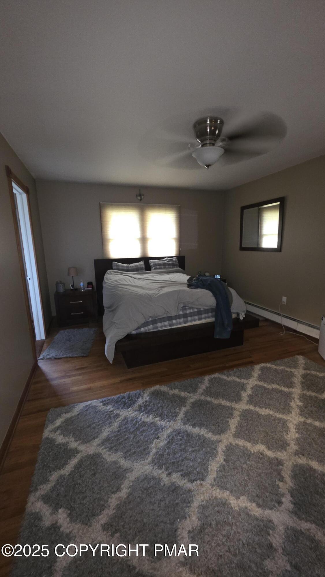 781 White Oak Road Cresco, PA 18326 - Photo 15 of 37 a spacious bedroom with a bed and a chandelier