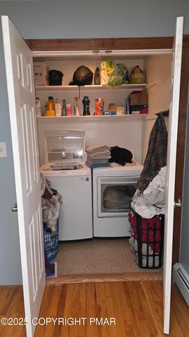a view of washer and dryer with kitchen in the background