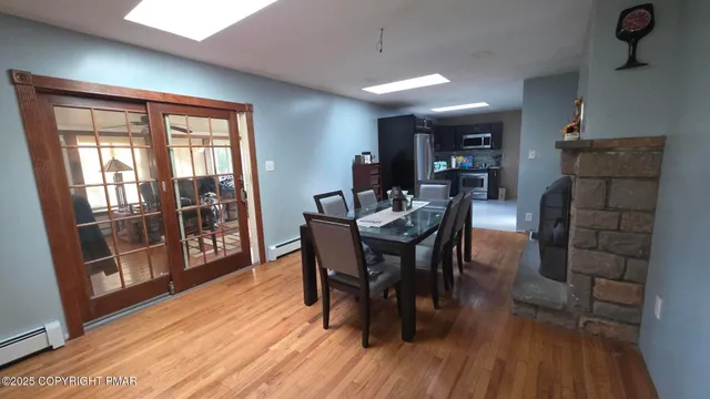 a dining room with furniture and wooden floor