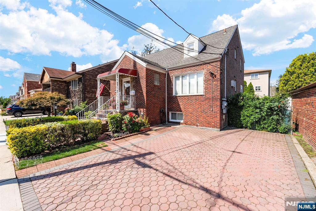 461 9th Street, Unit 2 Fairview, NJ 07022 - Photo 18 of 19 a front view of a house with a yard
