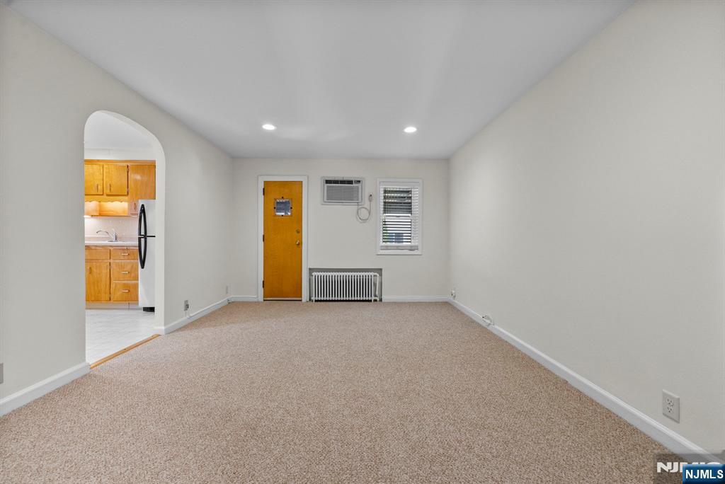 461 9th Street, Unit 2 Fairview, NJ 07022 - Photo 2 of 19 an empty room with a window and balcony view