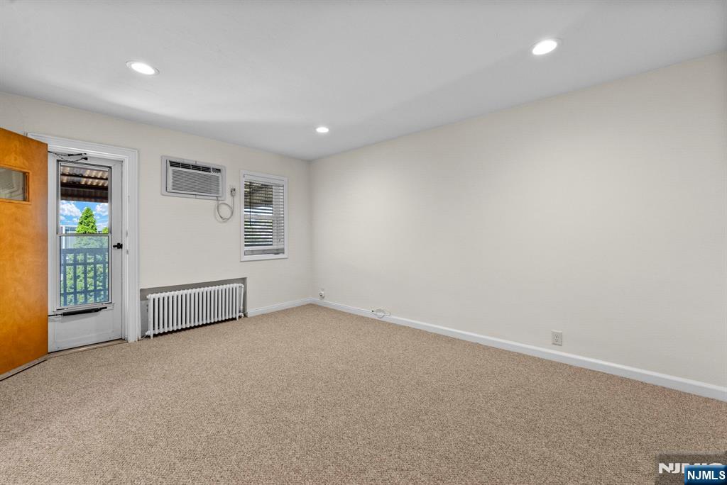 461 9th Street, Unit 2 Fairview, NJ 07022 - Photo 4 of 19 an empty room with windows