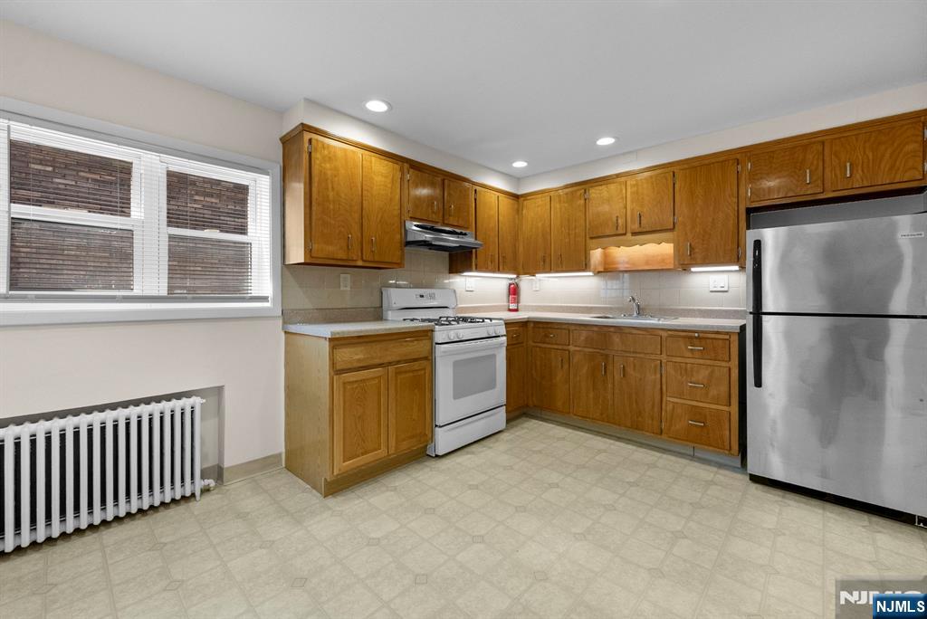 461 9th Street, Unit 2 Fairview, NJ 07022 - Photo 7 of 19 a kitchen with a sink cabinets and window