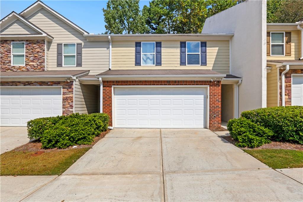 1221 Rockfield Circle Norcross, GA 30093 - Photo 2 of 10 a front view of a house with garden